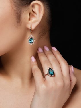 model-shows-earrings-ring-with-beautiful-blue-precious-stones